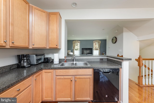 kitchen with sink, light wood-type flooring, black dishwasher, and light brown cabinetry