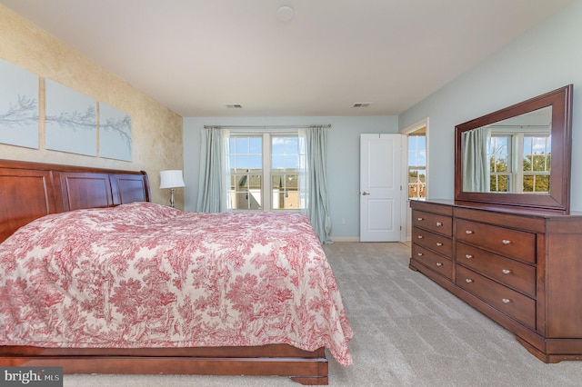 carpeted bedroom with multiple windows