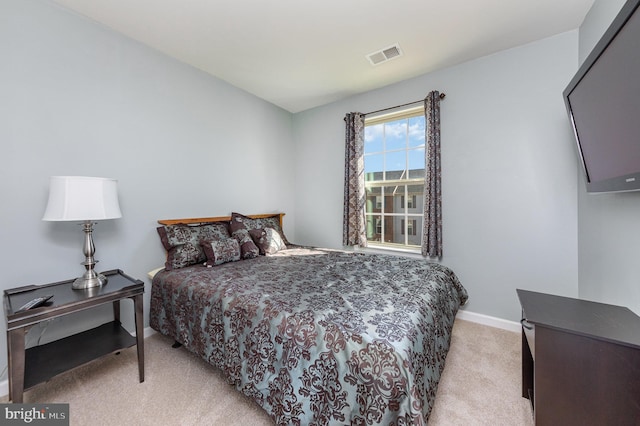 bedroom with light colored carpet