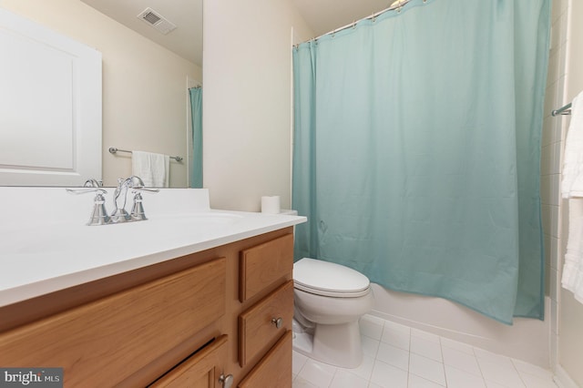 full bathroom with tile patterned floors, shower / tub combo with curtain, vanity, and toilet