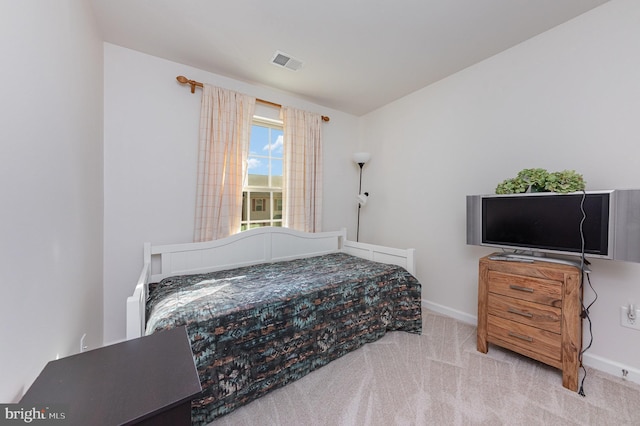 bedroom featuring light colored carpet