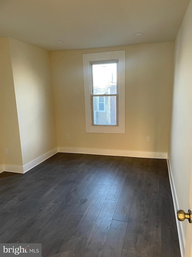 empty room with dark hardwood / wood-style floors