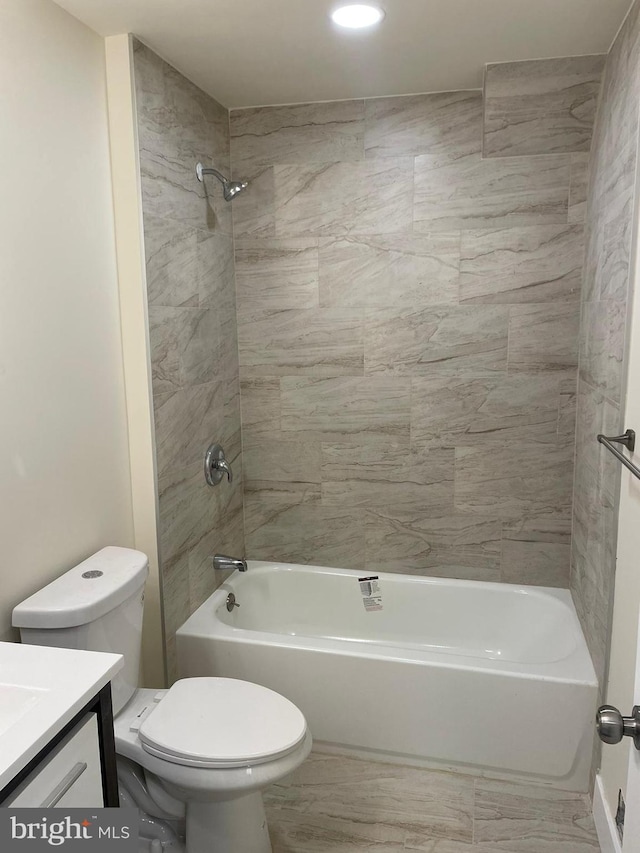 full bathroom with toilet, tiled shower / bath combo, and vanity