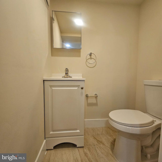 bathroom with toilet and vanity