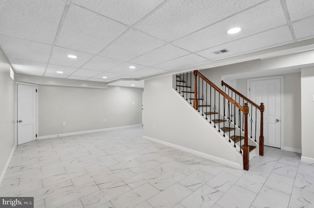 basement featuring a drop ceiling