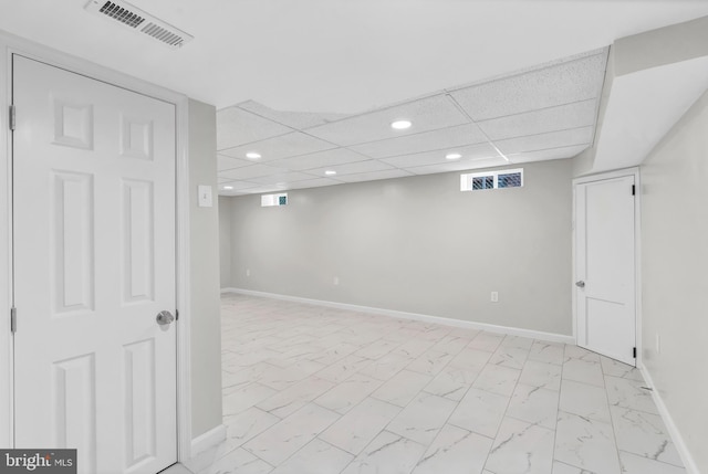 basement featuring a drop ceiling