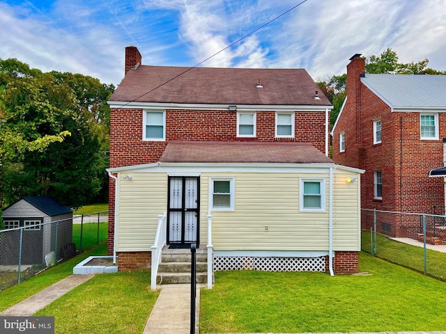 back of property with a lawn