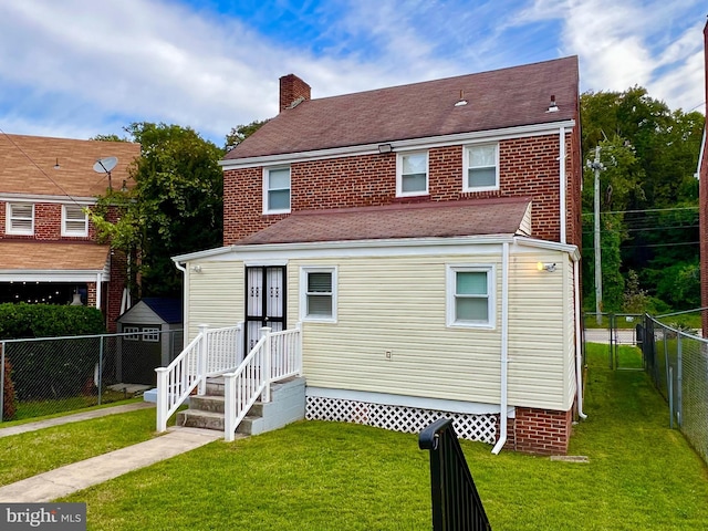 rear view of house with a yard