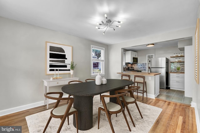 dining room featuring light hardwood / wood-style floors and a chandelier