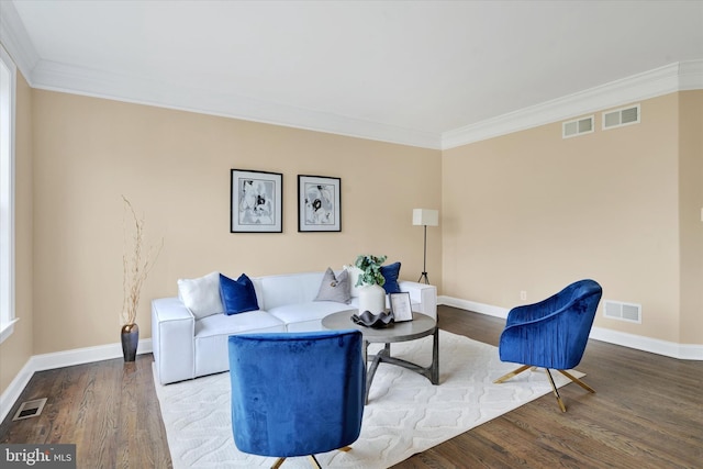 living room featuring hardwood / wood-style flooring and crown molding