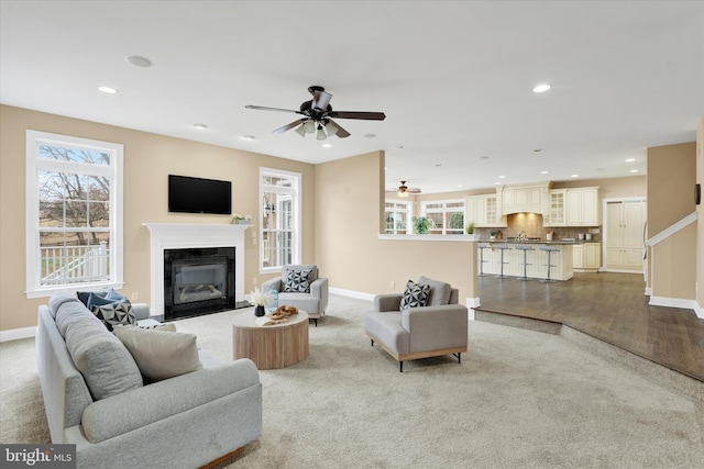 living room featuring light hardwood / wood-style floors and ceiling fan