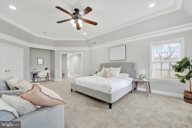 carpeted bedroom featuring ensuite bath, ceiling fan, and ornamental molding