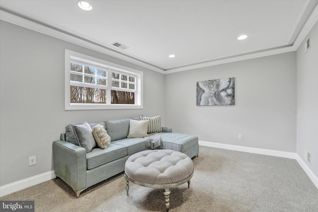 carpeted living room with ornamental molding