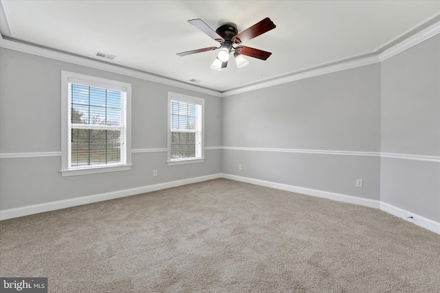 spare room with light carpet, ceiling fan, and crown molding