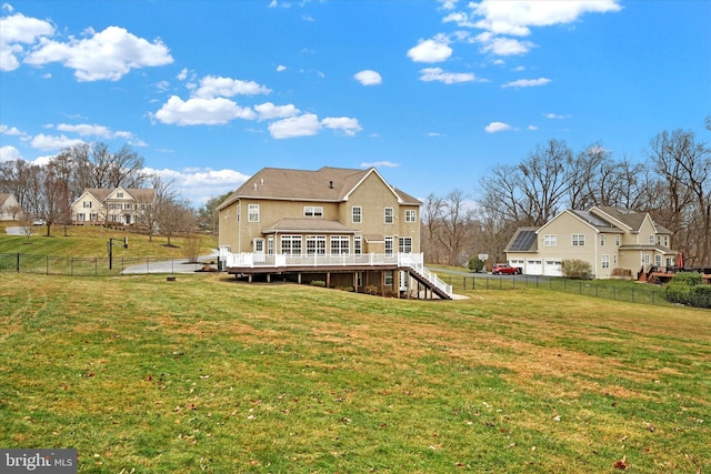 rear view of house with a yard and a deck