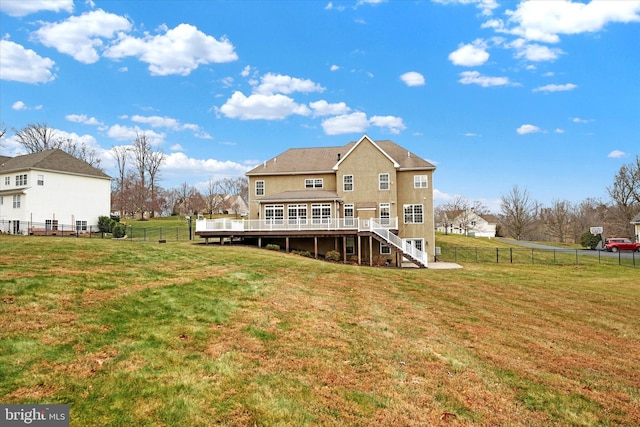 rear view of house featuring a yard, a rural view, and a deck