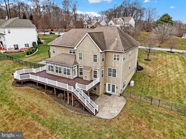 back of property featuring a yard, french doors, and a deck