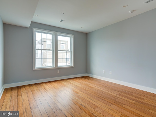 spare room with light wood-type flooring