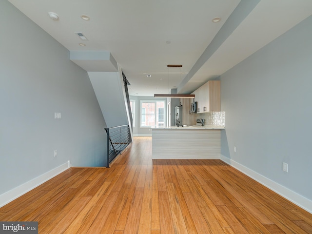 unfurnished living room featuring light hardwood / wood-style flooring