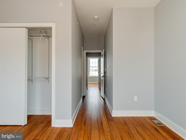 hallway with wood-type flooring