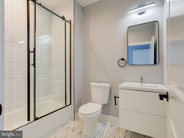 full bathroom featuring tile patterned flooring, vanity, bath / shower combo with glass door, and toilet