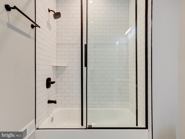 bathroom featuring bath / shower combo with glass door