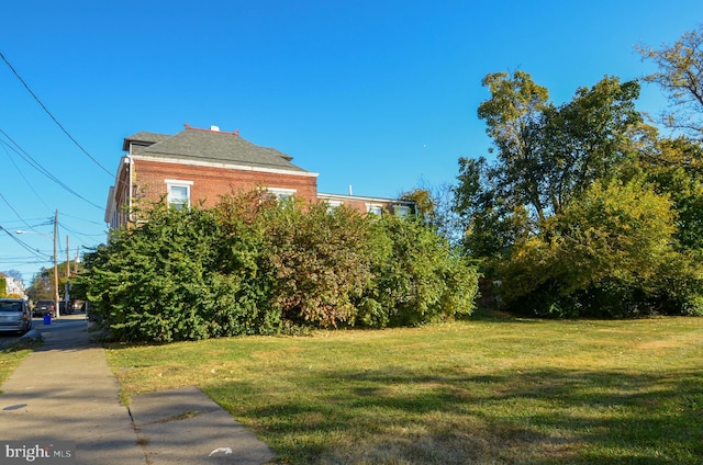 view of side of home featuring a lawn