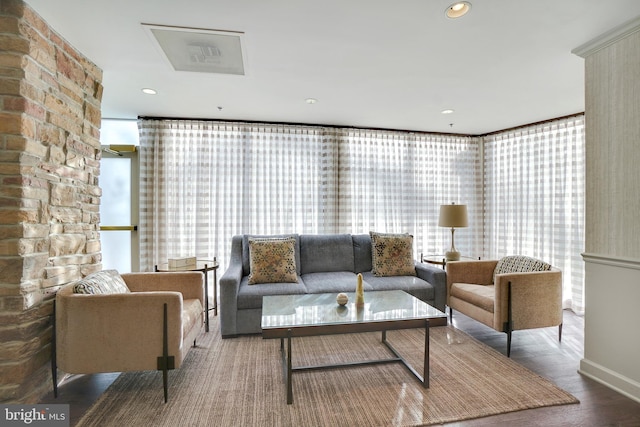 living area with a wall of windows, recessed lighting, and wood finished floors