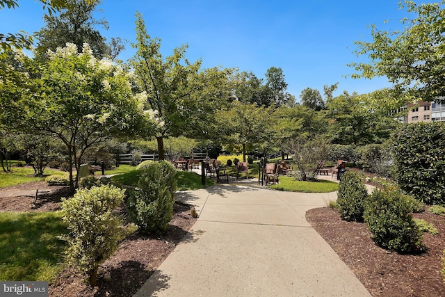 view of home's community featuring fence