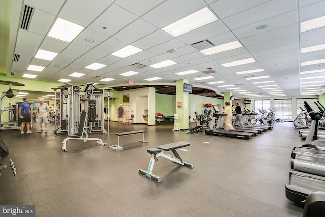 exercise room with a paneled ceiling and visible vents