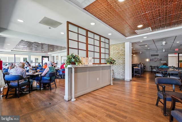 interior space featuring recessed lighting, wood finished floors, visible vents, a raised ceiling, and an ornate ceiling