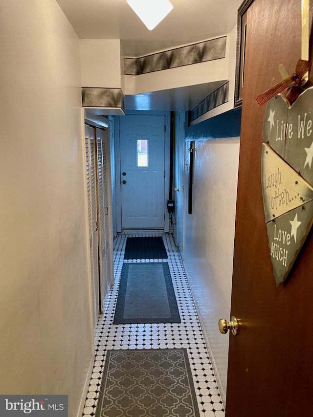 doorway featuring tile patterned flooring