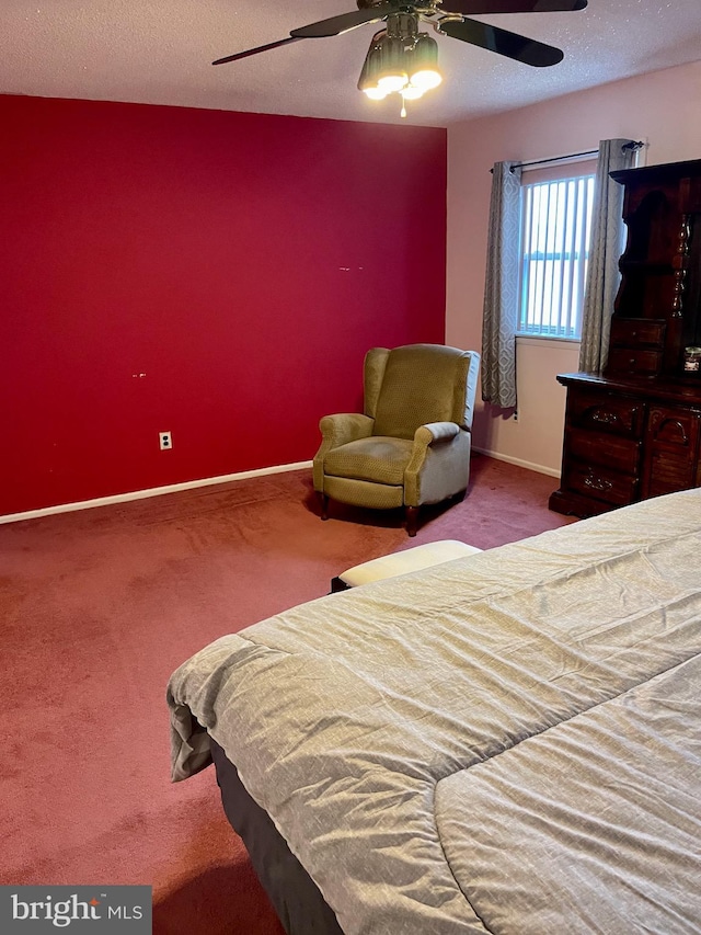 bedroom featuring carpet flooring, ceiling fan, and a textured ceiling