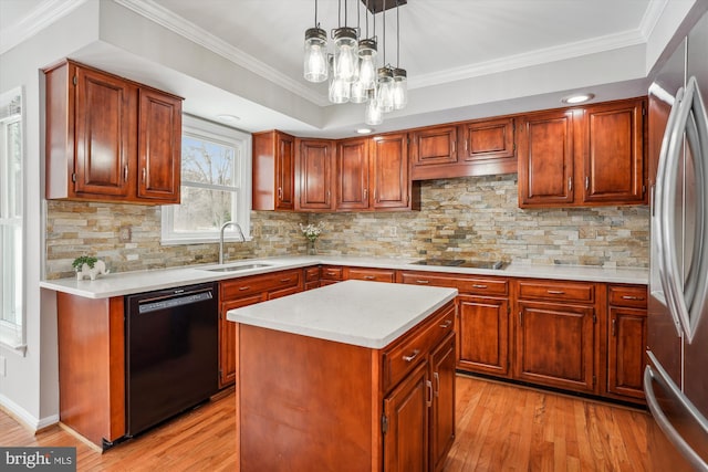 kitchen with decorative backsplash, black appliances, a kitchen island, pendant lighting, and sink