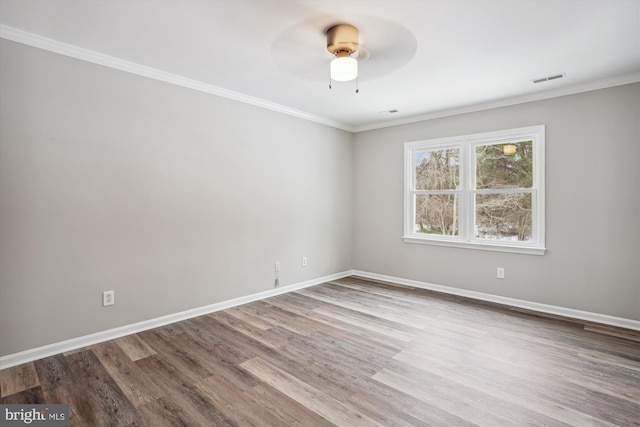 spare room with ceiling fan, ornamental molding, and hardwood / wood-style flooring