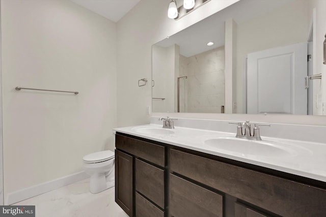 bathroom featuring vanity, toilet, and an enclosed shower