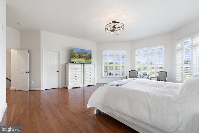 bedroom with dark hardwood / wood-style floors