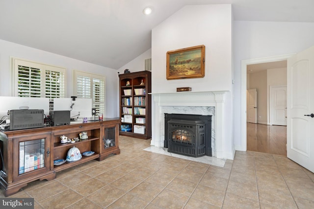 interior space featuring lofted ceiling and a fireplace