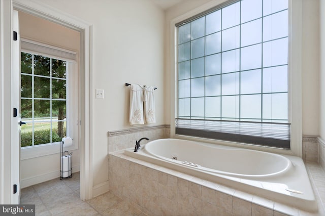 bathroom featuring tile patterned flooring and tiled tub