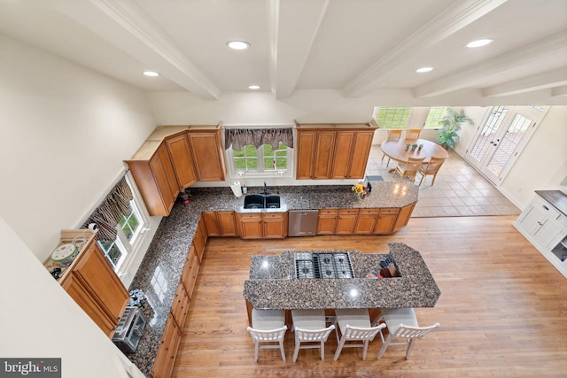 kitchen with french doors, crown molding, light wood-type flooring, stainless steel dishwasher, and beamed ceiling