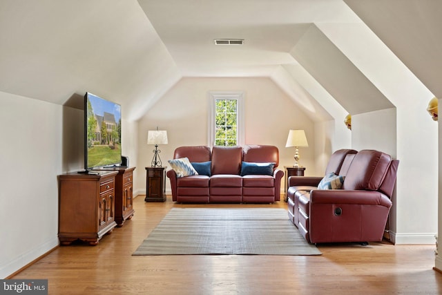 living room with lofted ceiling and light hardwood / wood-style floors