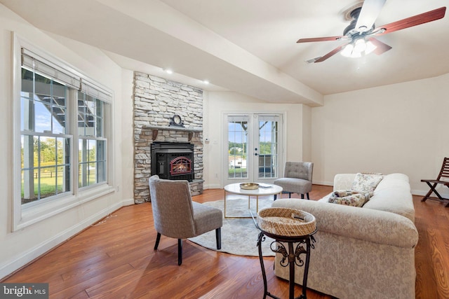 living room with hardwood / wood-style floors, a fireplace, and ceiling fan