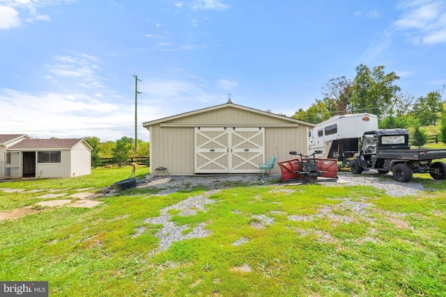 view of outbuilding featuring a lawn