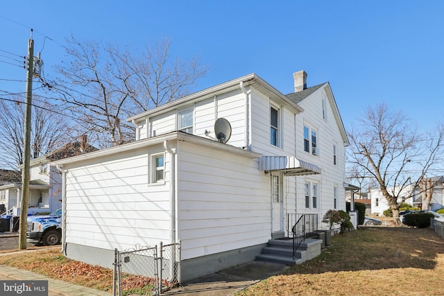 view of side of home with a chimney