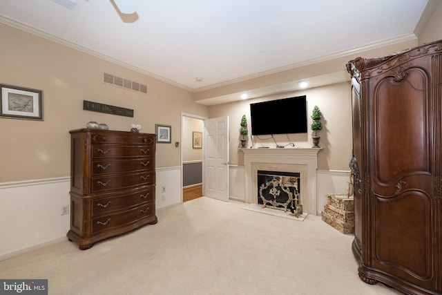 sitting room featuring ceiling fan, ornamental molding, and light carpet