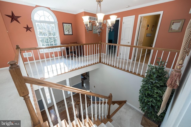 stairway featuring crown molding, carpet, and a notable chandelier