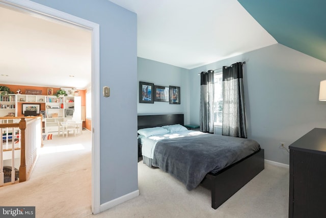 bedroom featuring carpet flooring and vaulted ceiling