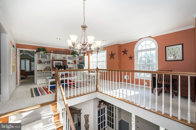 interior space with carpet flooring, ornamental molding, and a notable chandelier