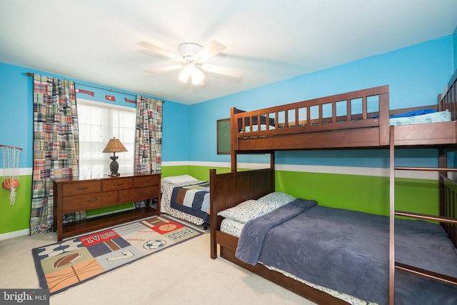 bedroom featuring ceiling fan and carpet