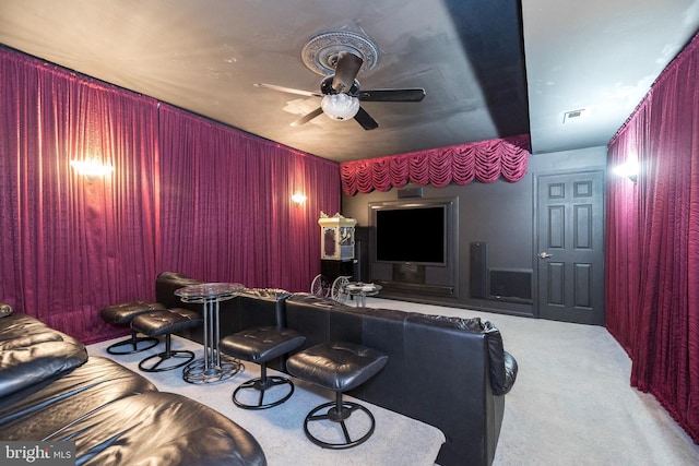 home theater room with light carpet and ceiling fan